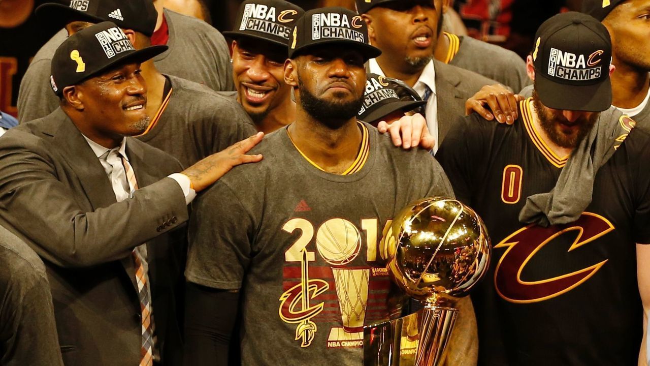 Cleveland Cavaliers forward LeBron James reacts while holding the Larry O'Brien trophy after defeating the Gold State Warriors to win the NBA Finals on June 19, 2016 in Oakland, California. Powered by an amazing effort from LeBron James, the Cleveland Cavaliers completed the greatest comeback in NBA Finals history, dethroning defending champion Golden State 93-89 to capture their first NBA title. The Cavaliers won the best-of-seven series 4-3 to claim the first league crown in their 46-season history and deliver the first major sports champion to Cleveland since the 1964 NFL Browns, ending the longest such title drought for any American city. / AFP / Beck Diefenbach