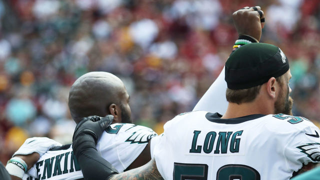 LANDOVER, MD - SEPTEMBER 10: Malcolm Jenkins #27 and Chris Long #56 of the Philadelphia Eagles react during the national anthem before the game against the Washington Redskins at FedExField on September 10, 2017 in Landover, Maryland.