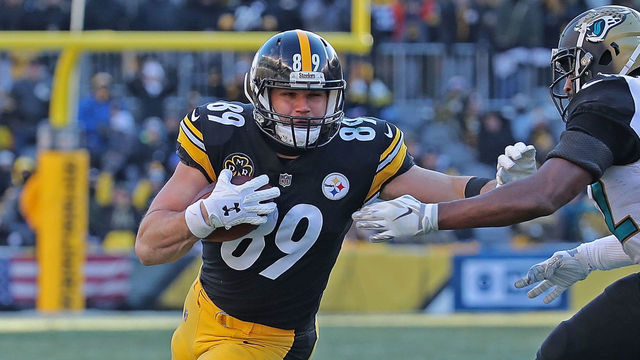 PITTSBURGH, PA - JANUARY 14: Vance McDonald #89 of the Pittsburgh Steelers stiff arms Barry Church #42 of the Jacksonville Jaguars after a reception in the third quarter during the AFC Divisional Playoff game at Heinz Field on January 14, 2018 in Pittsburgh, Pennsylvania.