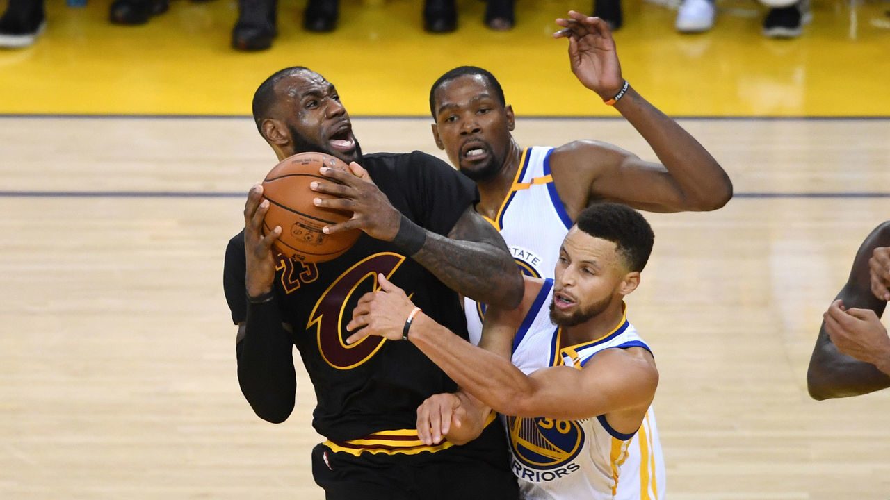OAKLAND, CA - JUNE 12: LeBron James #23 of the Cleveland Cavaliers is defended by Kevin Durant #35 and Stephen Curry #30 of the Golden State Warriors during the second half in Game 5 of the 2017 NBA Finals at ORACLE Arena on June 12, 2017 in Oakland, California.