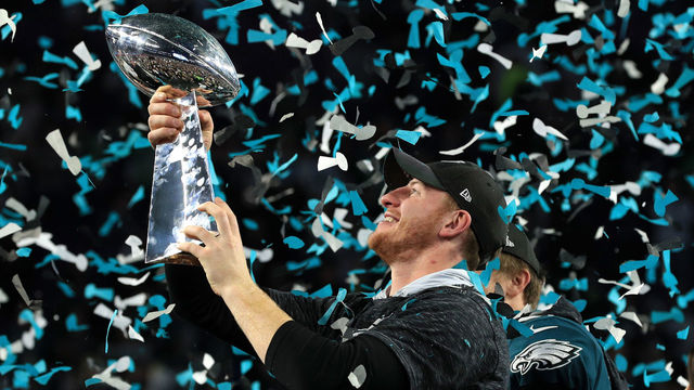 MINNEAPOLIS, MN - FEBRUARY 04: Injured quarterback Carson Wentz #11 of the Philadelphia Eagles holds the Lombardi Trophy after defeating the New England Patriots 41-33 in Super Bowl LII at U.S. Bank Stadium on February 4, 2018 in Minneapolis, Minnesota.