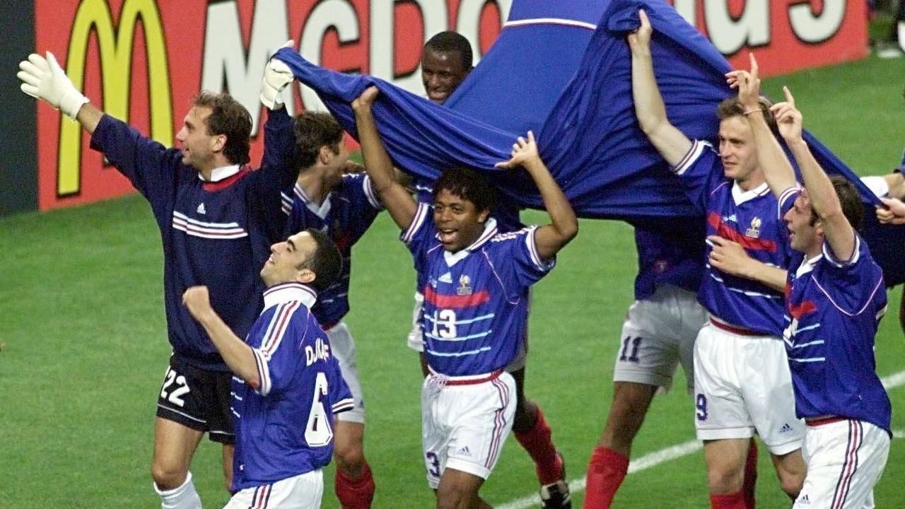 French players led by midfielder Youri Djorkaeff (#6) celebrate after France won its first-ever World Cup beating Brazil 3-0, 12 July at the Stade de France in Saint-Denis, north of Paris. (ELECTRONIC IMAGE)