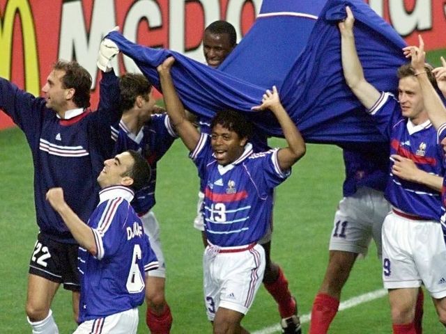 French players led by midfielder Youri Djorkaeff (#6) celebrate after France won its first-ever World Cup beating Brazil 3-0, 12 July at the Stade de France in Saint-Denis, north of Paris. (ELECTRONIC IMAGE)