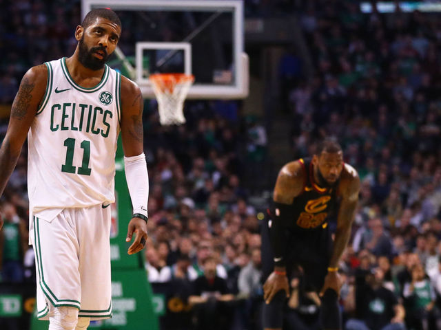 BOSTON, MA - JANUARY 3: LeBron James #23 of the Cleveland Cavaliers and Kyrie Irving #11 of the Boston Celtics look on during the second half at TD Garden on January 3, 2018 in Boston, Massachusetts.