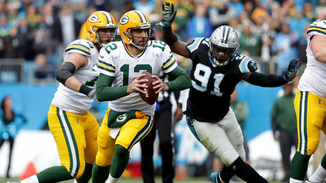 CHARLOTTE, NC - DECEMBER 17: Aaron Rodgers #12 of the Green Bay Packers runs the ball against the Carolina Panthers in the second quarter during their game at Bank of America Stadium on December 17, 2017 in Charlotte, North Carolina.