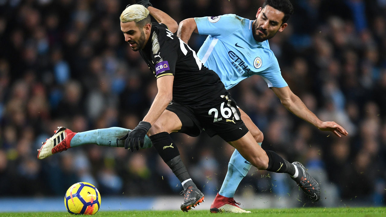MANCHESTER, ENGLAND - FEBRUARY 10: Riyad Mahrez of Leicester City is challenged by Ilkay Gundogan of Manchester City during the Premier League match between Manchester City and Leicester City at Etihad Stadium on February 10, 2018 in Manchester, England.