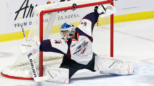WINDSOR, ON - SEPTEMBER 28: Goaltender Michael DiPietro #64 of the Windsor Spitfires deflects the puck over the net during a game against the Kitchener Rangers on September 28, 2017 at the WFCU Centre in Windsor, Ontario, Canada.