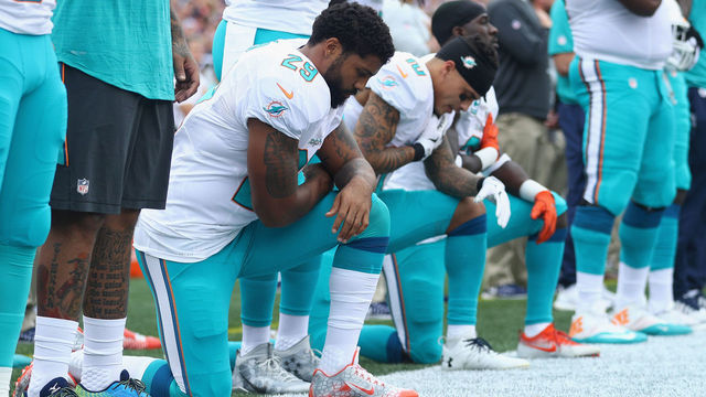 FOXBORO, MA - SEPTEMBER 18: (L-R) Arian Foster #29, Kenny Stills #10 and Michael Thomas #31 of the Miami Dolphins kneel during the national anthem before the game against the New England Patriots at Gillette Stadium on September 18, 2016 in Foxboro, Massachusetts.