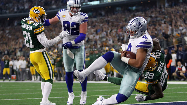 ARLINGTON, TX - OCTOBER 08: Dak Prescott #4 of the Dallas Cowboys falls into the end zone after scoring a touchdown in the fourth quarter of a football game at AT&T Stadium on October 8, 2017 in Arlington, Texas.