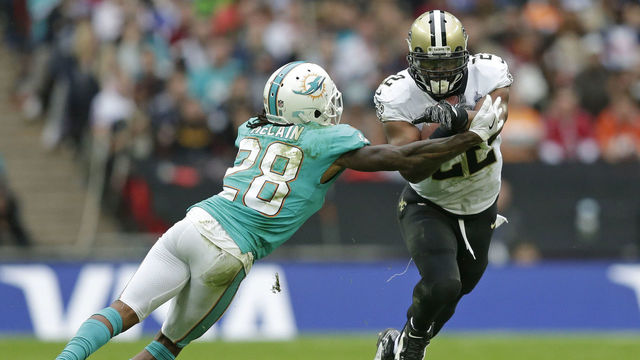 LONDON, ENGLAND - OCTOBER 01: Mark Ingram II #22 of the New Orleans Saints runs with the ball as Bobby McCain #28 of the Miami Dolphins atttemps a tackle during the NFL game between the Miami Dolphins and the New Orleans Saints at Wembley Stadium on October 1, 2017 in London, England.