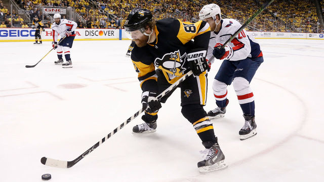 PITTSBURGH, PA - MAY 03: Phil Kessel #81 of the Pittsburgh Penguins skates the puck away from Lars Eller #20 of the Washington Capitals in Game Four of the Eastern Conference Second Round during the 2018 NHL Stanley Cup Playoffs at PPG PAINTS Arena on May 3, 2018 in Pittsburgh, Pennsylvania. *** Local Caption *** Phil Kessel;Lars Eller