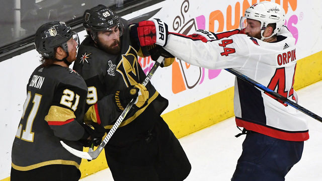 LAS VEGAS, NV - MAY 30: Brooks Orpik #44 of the Washington Capitals shoves Alex Tuch #89 of the Vegas Golden Knights in front of Cody Eakin #21 of the Golden Knights after Tuch's shot was blocked by Braden Holtby (not pictured) #70 of the Capitals late in the third period of Game Two of the 2018 NHL Stanley Cup Final at T-Mobile Arena on May 30, 2018 in Las Vegas, Nevada. The Capitals defeated the Golden Knights 3-2.