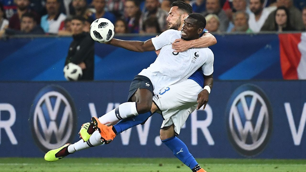 TOPSHOT - France's midfielder Paul Pogba (L) vies for the ball with Italy's defender Danilo D'Ambrosio during the friendly football match between France and Italy at the Allianz Riviera Stadium in Nice, southeastern France, on June 1, 2018.