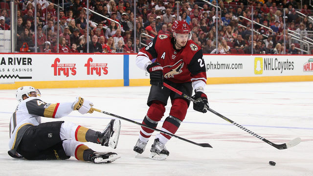 GLENDALE, AZ - OCTOBER 07: Oliver Ekman-Larsson #23 of the Arizona Coyotes moves the puck past Pierre-Edouard Bellemare #41 of the Vegas Golden Knights during the third period of the NHL game at Gila River Arena on October 7, 2017 in Glendale, Arizona. The Kinights defeated the Coyotes 2-1 in overtime.
