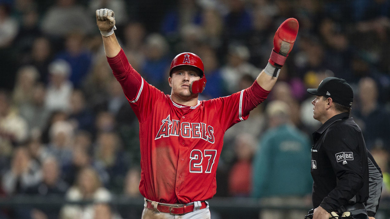 SEATTLE, WA - MAY 5: Mike Trout #27 of the Los Angeles Angels of Anaheim celebrates after scoring a run on an infield single by Andrelton Simmons #2 of the Los Angeles Angels of Anaheim off of relief pitcher Erik Goeddel #62 of the Seattle Mariners in the 11th inning of a game at Safeco Field on May 5, 2018 in Seattle, Washington.