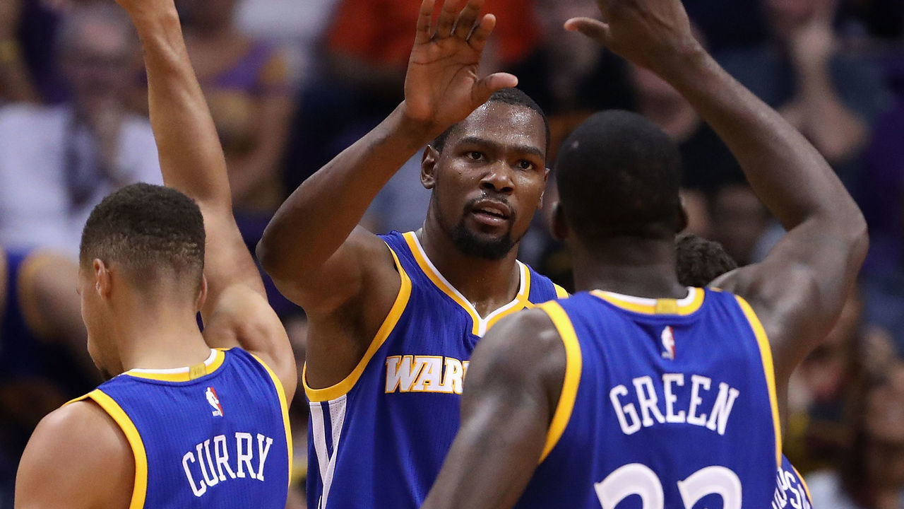 PHOENIX, AZ - OCTOBER 30: Kevin Durant #35 of the Golden State Warriors high fives Stephen Curry #30 and Draymond Green #23 after scoring against the Phoenix Suns during the second half of the NBA game at Talking Stick Resort Arena on October 30, 2016 in Phoenix, Arizona. The Warriors defeated the Suns 106 -100.
