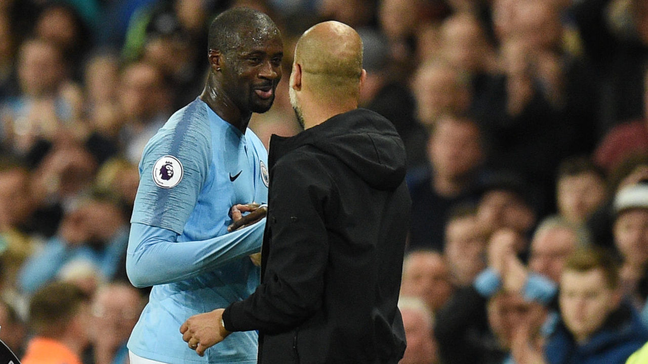 Manchester City's Spanish manager Pep Guardiola (R) embraces Manchester City's Ivorian midfielder Yaya Toure as he is substituted during the English Premier League football match between Manchester City and Brighton and Hove Albion at the Etihad Stadium in Manchester, north west England, on May 9, 2018.