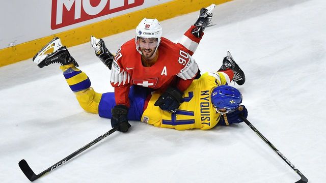 Switzerland's Roman Josi and Sweden's Gustav Nyquist vie during the final match Sweden vs Switzerland of the 2018 IIHF Ice Hockey World Championship at the Royal Arena in Copenhagen, Denmark, on May 20, 2018.