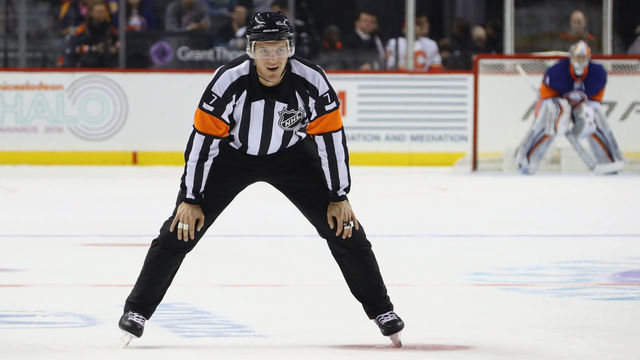 NEW YORK, NY - NOVEMBER 28: Referee Garrett Rank #7 works the game between the New York Islanders and the Calgary Flames at the Barclays Center on November 28, 2016 in the Brooklyn borough of New York City. The Islanders defeated the Flames 2-1 in overtime.