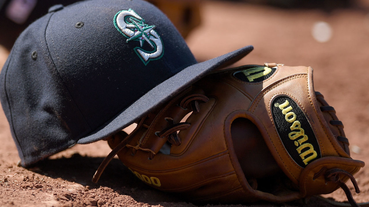 OAKLAND, CA - SEPTEMBER 10: A detailed view of the cap and Wilson baseball glove belonging to Ketel Marte #4 of the Seattle Mariners sitting on top of the dugout steps against the Oakland Athletics at Oakland-Alameda County Coliseum on September 10, 2016 in Oakland, California.