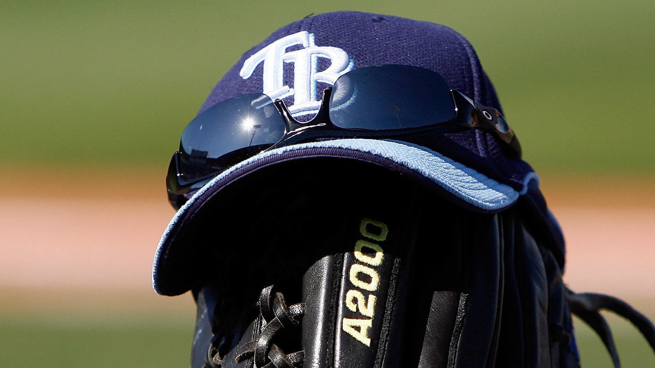 PORT CHARLOTTE, FL - FEBRUARY 27: A Rays hat and glove sit at the end of the dugout during a Grapefruit League Spring Training Game between the Boston Red Sox and the Tampa Bay Rays at Charlotte Sports Park on February 27, 2009 in Port Charlotte, Florida.