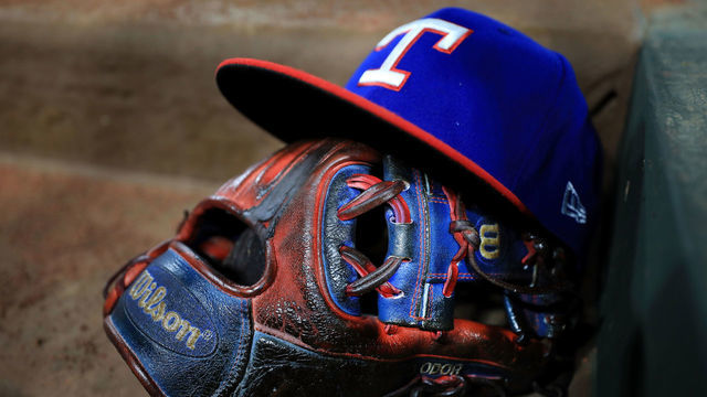 ARLINGTON, TX - JULY 08: A view of the glove and hat of Rougned Odor #12 of the Texas Rangers as the Texas Rangers take on the Los Angeles Angels at Globe Life Park in Arlington on July 8, 2017 in Arlington, Texas.