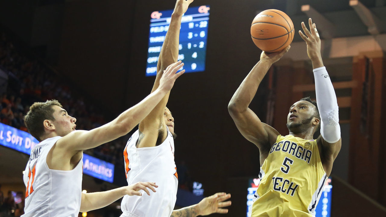 CHARLOTTESVILLE, VA - FEBRUARY 21: Josh Okogie #5 of the Georgia Tech Yellow Jackets shoots over Devon Hall #0 and Ty Jerome #11 of the Virginia Cavaliers in the first half during a game at John Paul Jones Arena on February 21, 2018 in Charlottesville, Virginia.