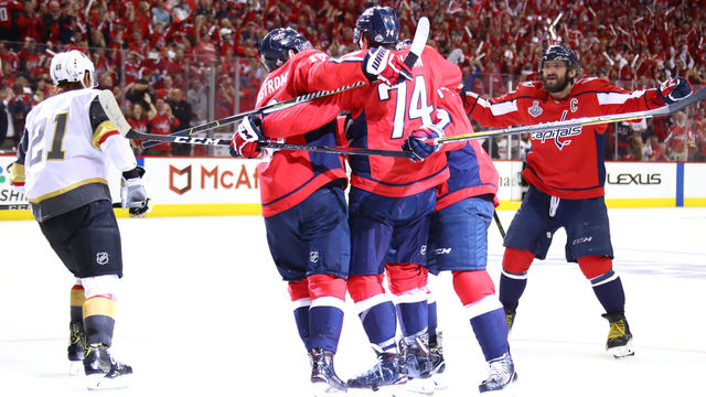 WASHINGTON, DC - JUNE 04: John Carlson #74 of the Washington Capitals is congratulated by his teammates after scoring a second-period goal against the Vegas Golden Knights in Game Four of the 2018 NHL Stanley Cup Final at Capital One Arena on June 4, 2018 in Washington, DC.