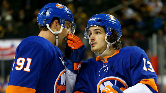 NEW YORK, NY - JANUARY 18: John Tavares #91 of the New York Islanders talks strategy with teammate Mathew Barzal #13 during the third period against the Boston Bruins at Barclays Center on January 18, 2018 in New York City.