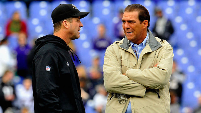 BALTIMORE, MD - DECEMBER 28: Head coach John Harbaugh of the Baltimore Ravens (L) speaks with Baltimore Ravens owner Steve Bisciotti (R) before a game against the Cleveland Browns at M&T Bank Stadium on December 28, 2014 in Baltimore, Maryland.