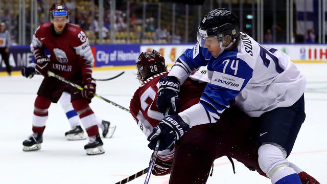 HERNING, DENMARK - MAY 06: Uvis Balinskis (L) of Latvia and Antti Suomela of Finland battle for the puck during the 2018 IIHF Ice Hockey World Championship group stage game between Latvia and Finland at Jyske Bank Boxen on May 6, 2018 in Herning, Denmark.