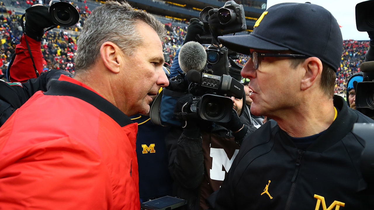 ANN ARBOR, MI - NOVEMBER 25: Urban Meyer head coach of the Ohio State Buckeyes and Jim Harbaugh head coach of the Michigan Wolverines shake hands after the game. Ohio State won 31 to 20 on November 25, 2017 at Michigan Stadium in Ann Arbor, Michigan.