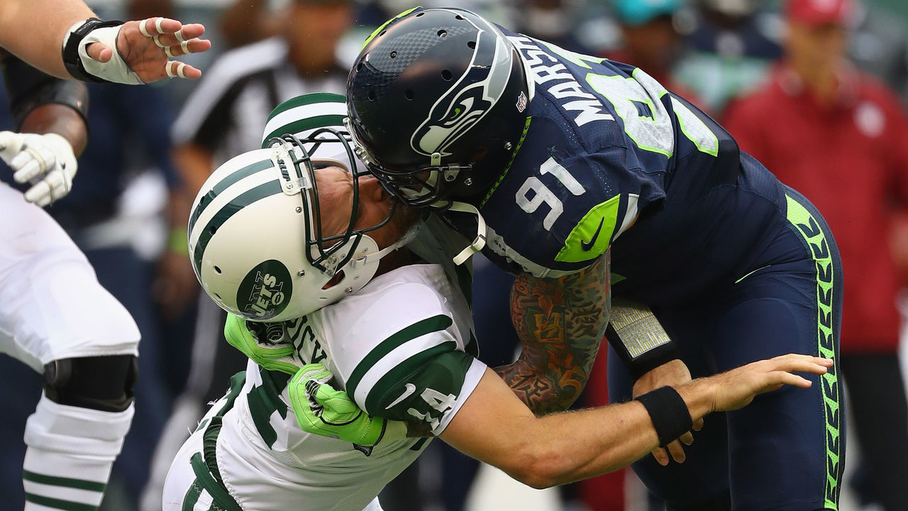 EAST RUTHERFORD, NJ - OCTOBER 02: Cassius Marsh #91 of the Seattle Seahawks hits his helmet against quarterback Ryan Fitzpatrick #14 of the New York Jets for a penalty 'Roughing the Passer' in the second quarter at MetLife Stadium on October 2, 2016 in East Rutherford, New Jersey.