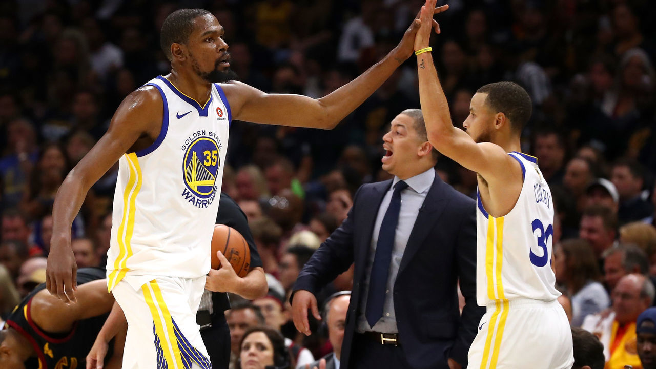 CLEVELAND, OH - JUNE 08: Kevin Durant #35 and Stephen Curry #30 of the Golden State Warriors react as Tyronn Lue of the Cleveland Cavaliers looks on in the first half during Game Four of the 2018 NBA Finals at Quicken Loans Arena on June 8, 2018 in Cleveland, Ohio.