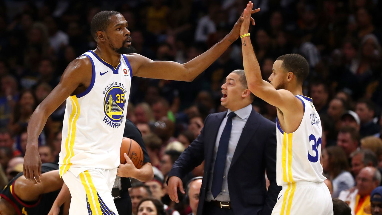 CLEVELAND, OH - JUNE 08: Kevin Durant #35 and Stephen Curry #30 of the Golden State Warriors react as Tyronn Lue of the Cleveland Cavaliers looks on in the first half during Game Four of the 2018 NBA Finals at Quicken Loans Arena on June 8, 2018 in Cleveland, Ohio.
