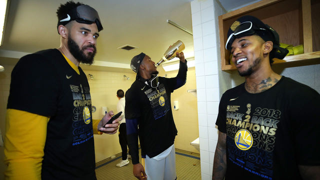 CLEVELAND, OH - JUNE 08: JaVale McGee #1, David West #3 and Nick Young #6 of the Golden State Warriors celebrate in the locker room after defeating the Cleveland Cavaliers during Game Four of the 2018 NBA Finals at Quicken Loans Arena on June 8, 2018 in Cleveland, Ohio. The Warriors defeated the Cavaliers 108-85 to win the 2018 NBA Finals.