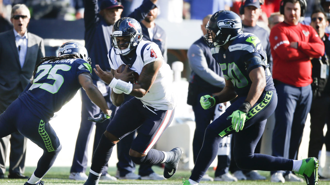 SEATTLE, WA - OCTOBER 29: Quarterback Deshaun Watson #4 of the Houston Texans prepares for a tackle as he rushes against cornerback Richard Sherman #25 of the Seattle Seahawks in the third quarter at CenturyLink Field on October 29, 2017 in Seattle, Washington.