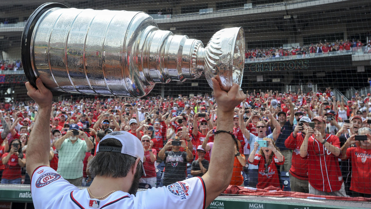 WASHINGTON, DC - JUNE 09: Washington Capitals captain, Alex Ovechkin walks off the field with the Stanley Cup held over his head prior to the game between the San Fransisco Giants and the Washington Nationals on June 9, 2018, at Nationals Park, in Washington D.C.