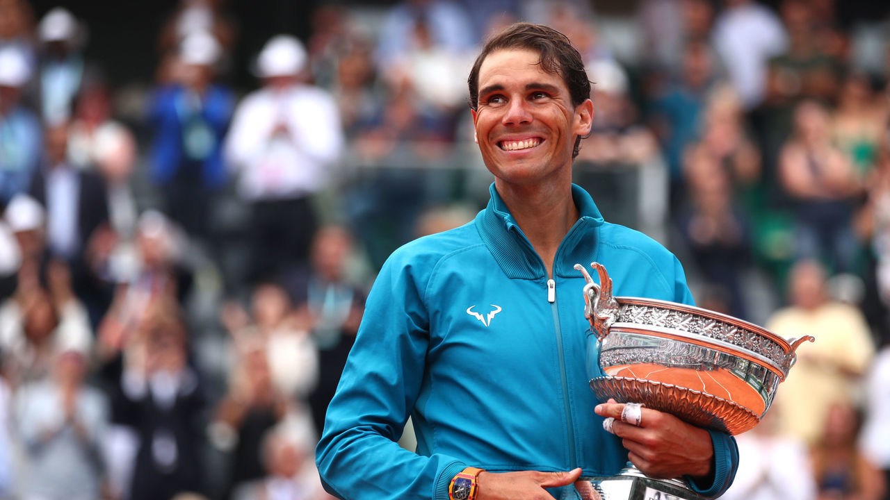 PARIS, FRANCE - JUNE 10: Rafael Nadal of Spain hugs the Musketeers' Cup as he celebrates victory following the mens singles final against Dominic Thiem of Austria during day fifteen of the 2018 French Open at Roland Garros on June 10, 2018 in Paris, France.