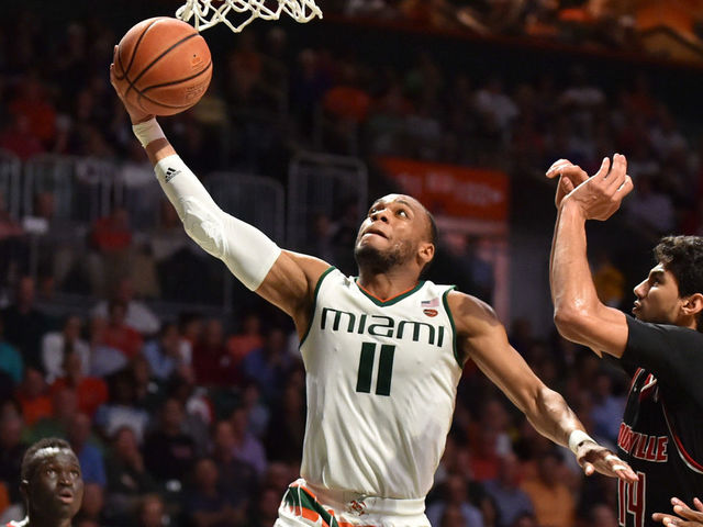 MIAMI, FL - JANUARY 24: Bruce Brown Jr. #11 of the Miami Hurricanes drives to the basket while being defended by Anas Mahmoud #14 of the Louisville Cardinals during the second half of the game at The Watsco Center on January 24, 2018 in Miami, Florida.