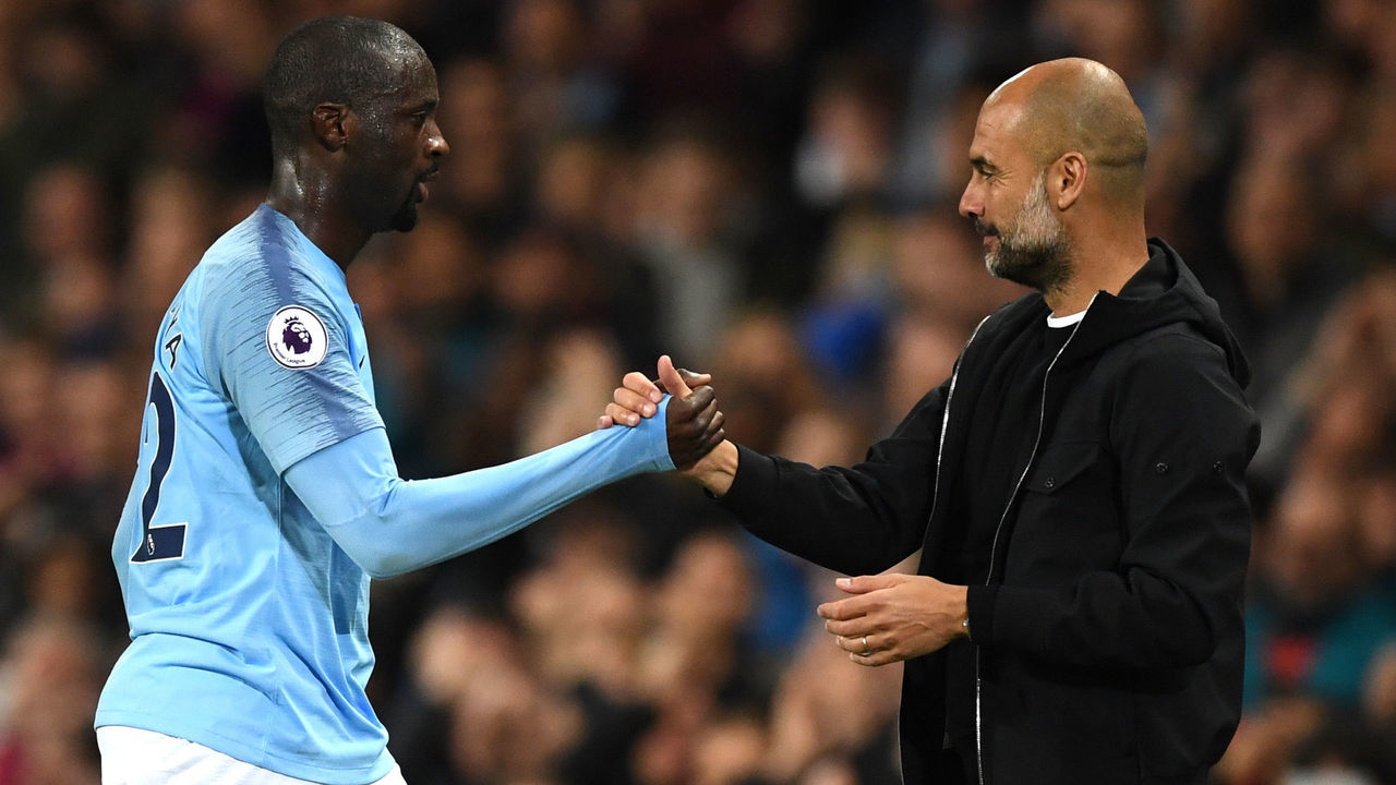 MANCHESTER, ENGLAND - MAY 09: Yaya Toure of Manchester City shakes hands wtih Josep Guardiola, Manager of Manchester City after he is subbed off during the Premier League match between Manchester City and Brighton and Hove Albion at Etihad Stadium on May 9, 2018 in Manchester, England.