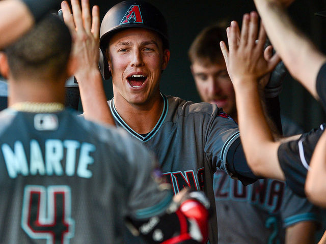 DENVER, CO - JUNE 8: Jake Lamb #22 of the Arizona Diamondbacks celebrates in the dugout after hitting a third inning homerun against the Colorado Rockies at Coors Field on June 8, 2018 in Denver, Colorado.