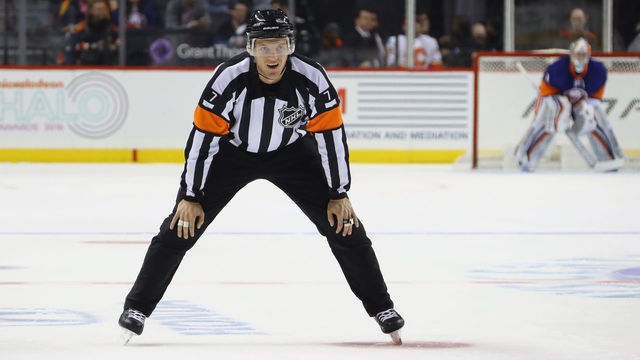 NEW YORK, NY - NOVEMBER 28: Referee Garrett Rank #7 works the game between the New York Islanders and the Calgary Flames at the Barclays Center on November 28, 2016 in the Brooklyn borough of New York City. The Islanders defeated the Flames 2-1 in overtime.