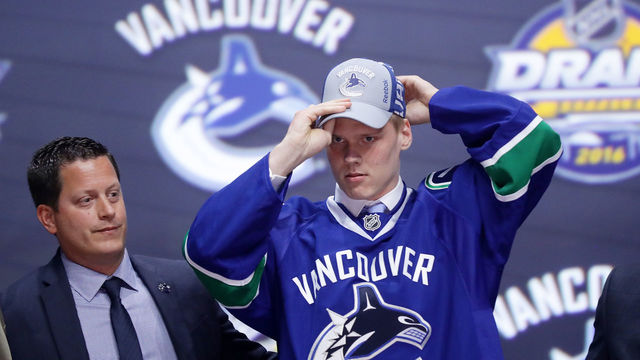 BUFFALO, NY - JUNE 24: Olli Juolevi celebrates with the Vancouver Canucks after being selected fifth overall during round one of the 2016 NHL Draft on June 24, 2016 in Buffalo, New York.