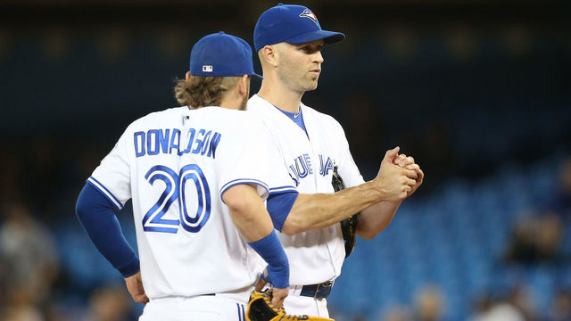 TORONTO, CANADA - MAY 16: J.A. Happ #33 of the Toronto Blue Jays is joined on the mound by Josh Donaldson #20 as he waits for pitching coach Pete Walker #40 to make the trip to the mound in the third inning during MLB game action against the Tampa Bay Rays on May 16, 2016 at Rogers Centre in Toronto, Ontario, Canada.