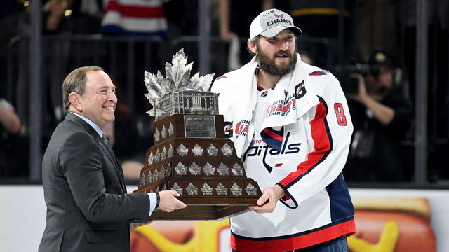 LAS VEGAS, NV - JUNE 07: Alex Ovechkin #8 of the Washington Capitals is presented the Conn Smythe Trophy by NHL Commissioner Gary Bettman after his team defeated the Vegas Golden Knights 4-3 in Game Five of the 2018 NHL Stanley Cup Final at T-Mobile Arena on June 7, 2018 in Las Vegas, Nevada.