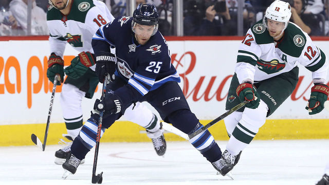 WINNIPEG, MANITOBA - APRIL 20: Paul Stastny #25 of the Winnipeg Jets moves the puck under pressure from Eric Staal #12 and Jordan Greenway #18 of the Minnesota Wild in Game Five of the Western Conference First Round during the 2018 NHL Stanley Cup Playoffs on April 20, 2018 at Bell MTS Place in Winnipeg, Manitoba, Canada.