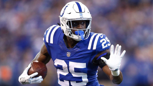 INDIANAPOLIS, IN - DECEMBER 31: Marlon Mack #25 of the Indianapolis Colts pushes off a tackle from Kevin Johnson #30 of the Houston Texans during the second half at Lucas Oil Stadium on December 31, 2017 in Indianapolis, Indiana.