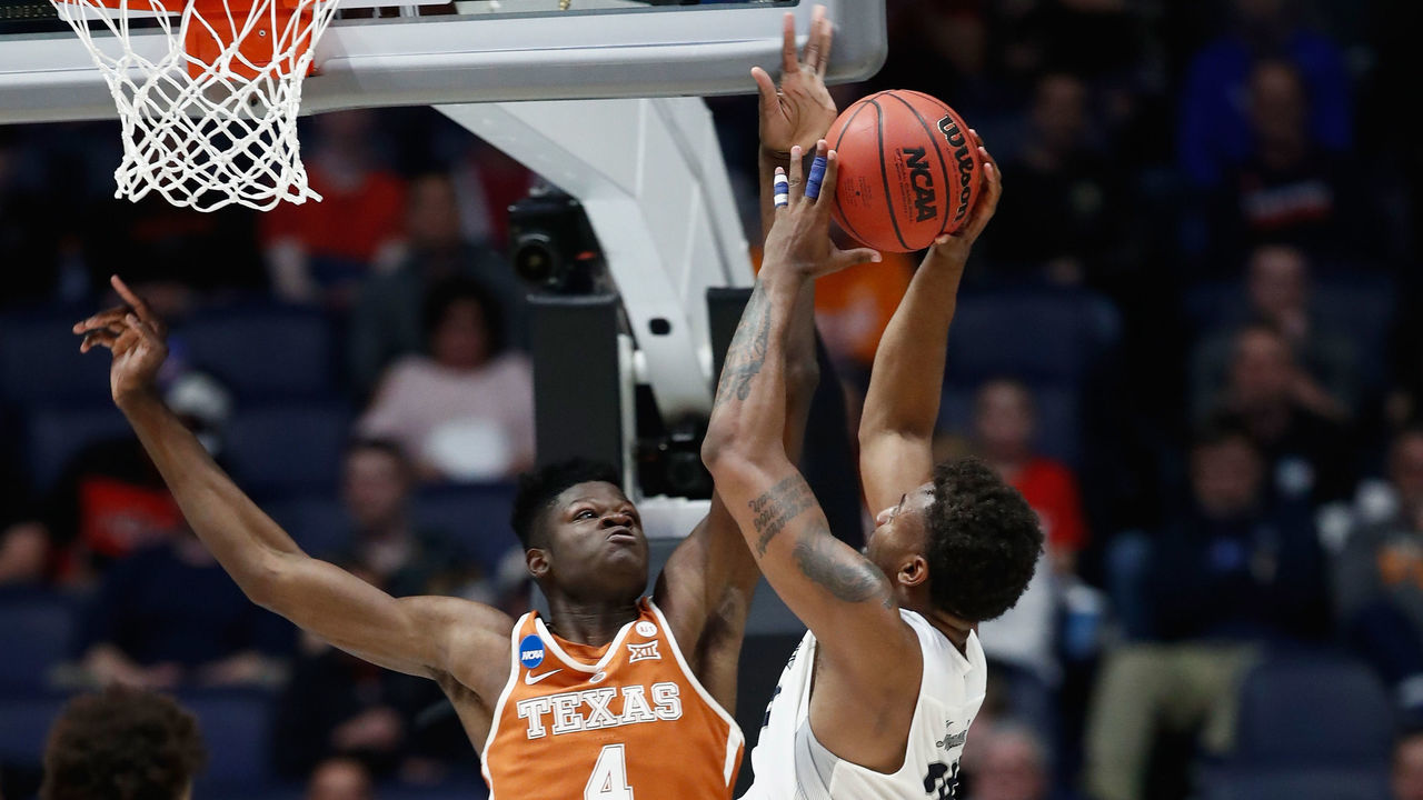 NASHVILLE, TN - MARCH 16: Mohamed Bamba #4 of the Texas Longhorns blocks a shot by Jordan Caroline #24 of the Nevada Wolf Pack during the game in the first round of the 2018 NCAA Men's Basketball Tournament at Bridgestone Arena on March 16, 2018 in Nashville, Tennessee.