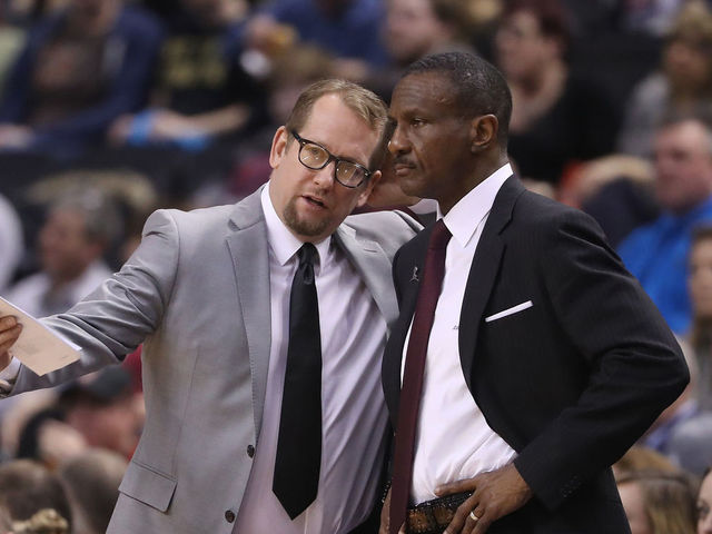 TORONTO, ON - FEBRUARY 15: Head coach Dwane Casey of the Toronto Raptors listens to assistant coach Nick Nurse against the Charlotte Hornets during NBA game action at Air Canada Centre on February 15, 2017 in Toronto, Canada.